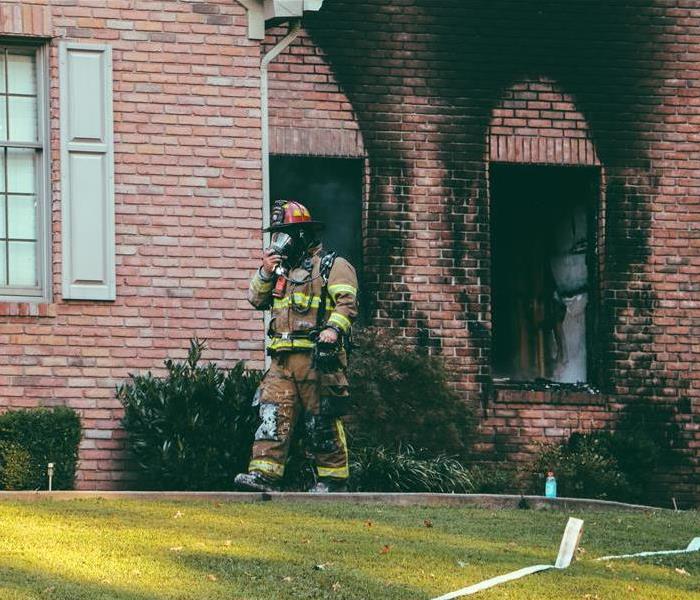 Fireman in front of House