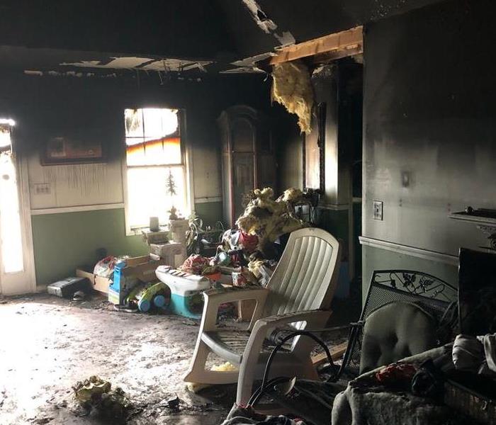 A room with toys and furniture with fire damage